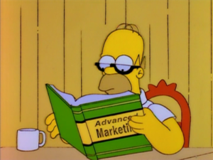 Homero simpson estudiando marketing con un libro y anteojos
